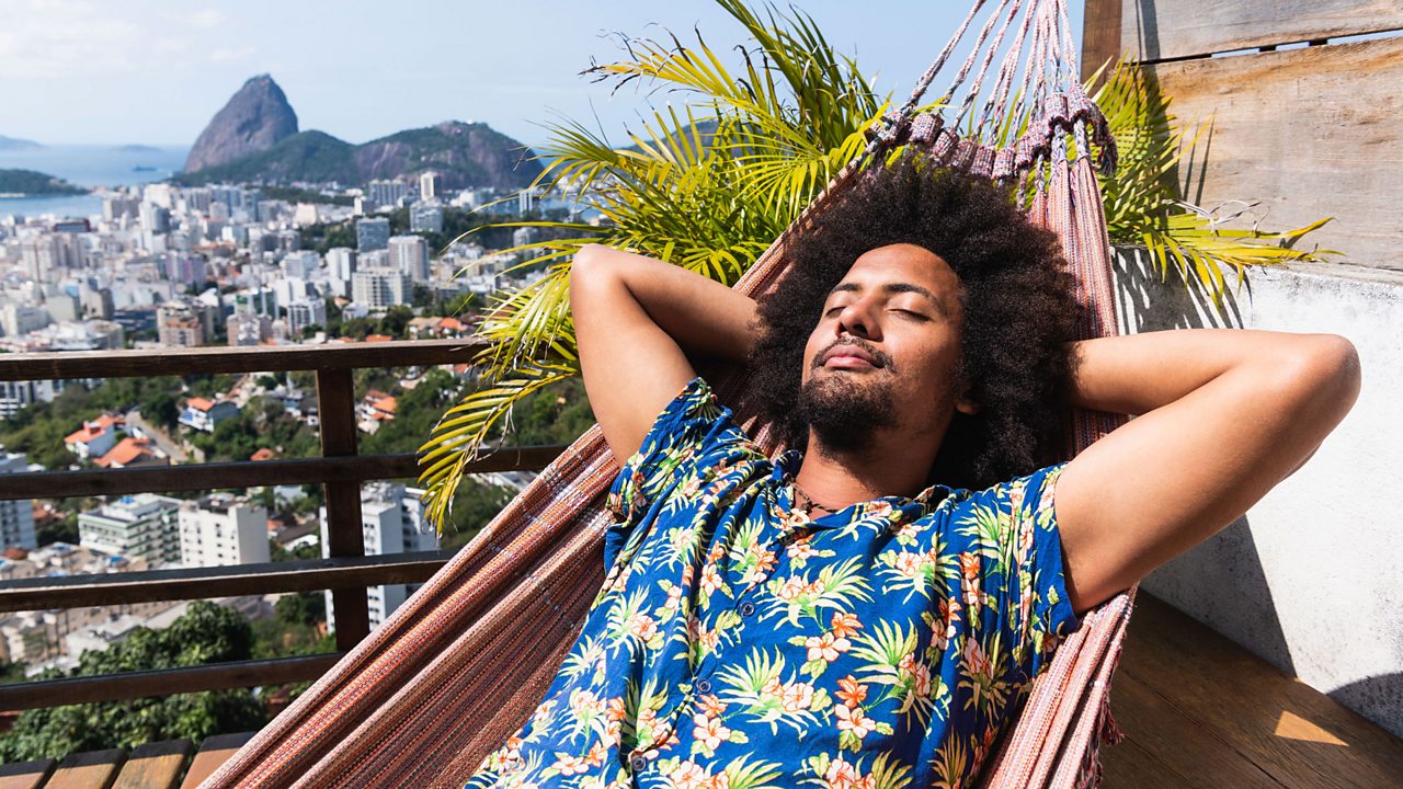 A man relaxing in a hammock.