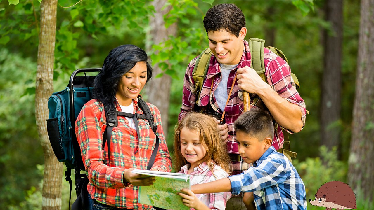 A photo of a family looking at a map outdoors