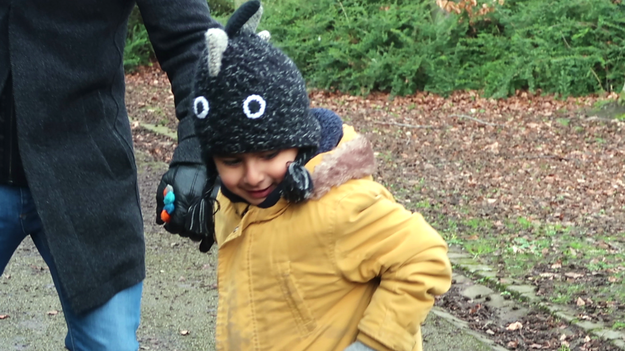 Boy in woolly hat outdoors