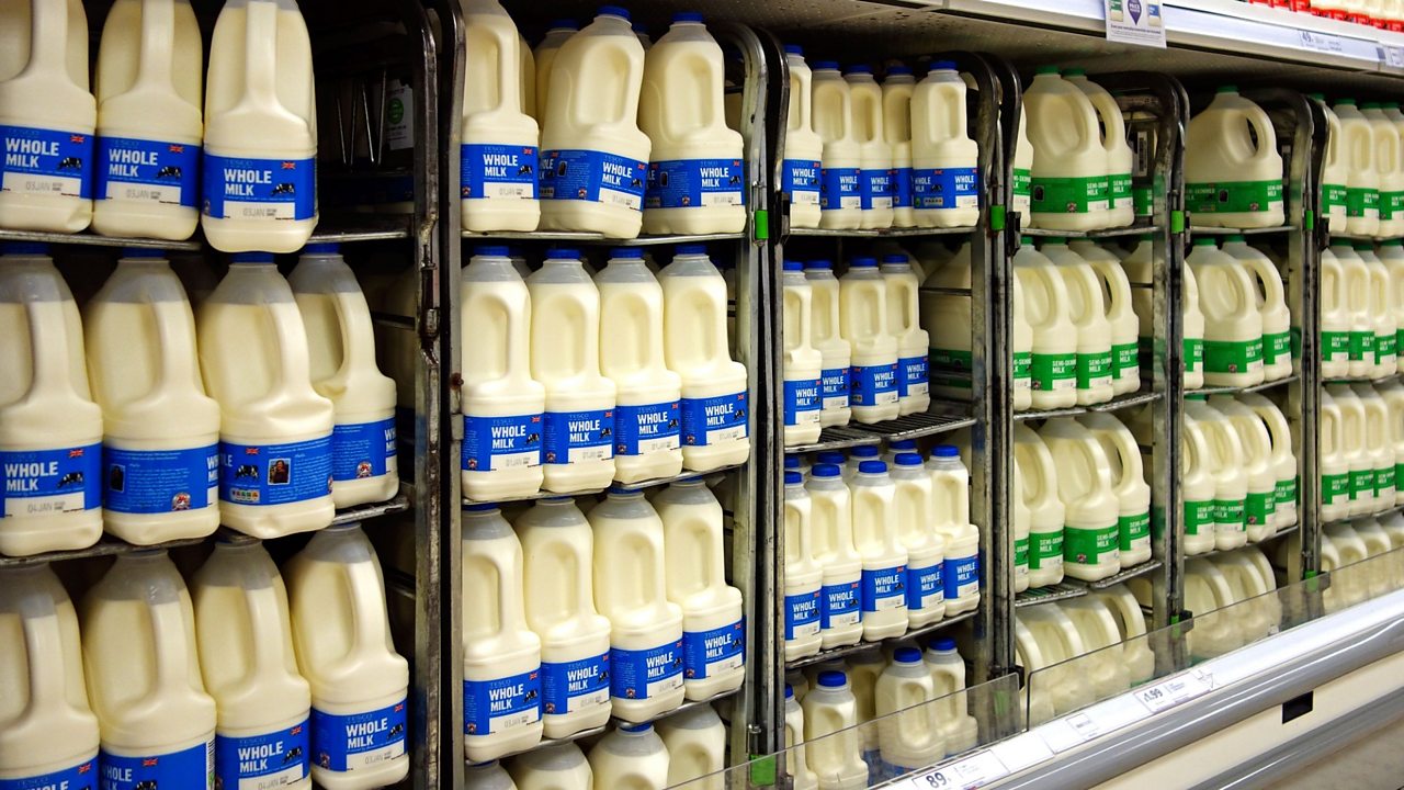 Milk bottles on supermarket shelves