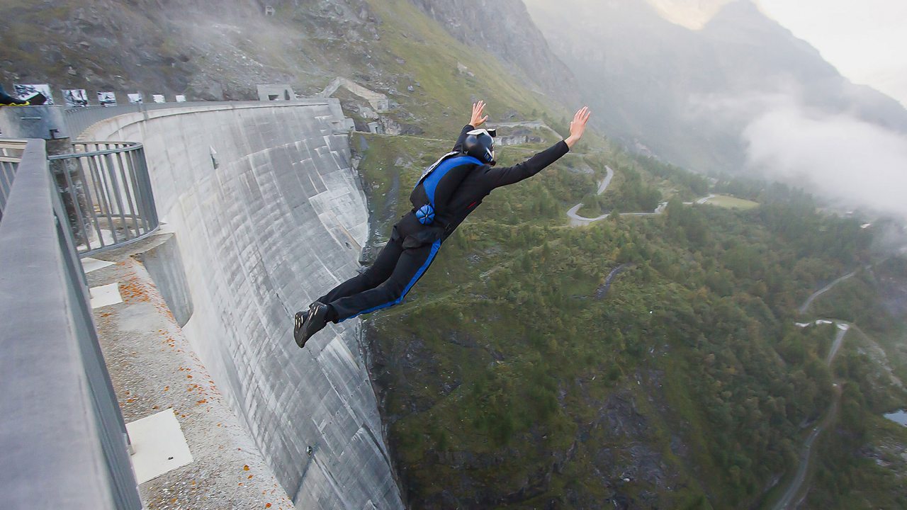 A base jumper jumps from a dam. His gravitational store empties.