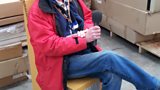 Colin tries out a cardboard chair