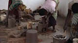 Women making clay stoves