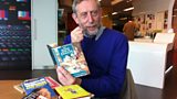 Michael Rosen with his book of insults