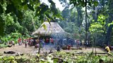 Villagers gather at a traditional sacred house, known as an Uma Lulik
