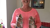 Sioned holds up a pair of her shoes