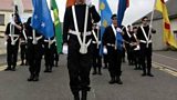Children dressed in paramilitary uniform take part in Republican parade