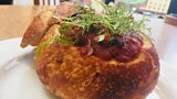 “Breakfast in bed” sourdough roll filled with butterbean fabada and poached eggs