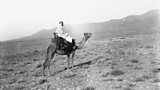 Don on a camel in Morocco for his book Mogreb-el-Acksa (1898)