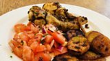 Chicken drumsticks served with banana plantains and salsa salad