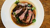 Jerk duck breasts with rice and peas, spinach and jerk spiced gravy