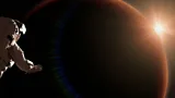 Astronaut watching the sunrise during a space walk in orbit of planet Mars