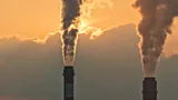 Smoke rising from chimneys at a power plant in eastern China (Credit: Getty Images)