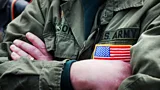 A close-up of US Army veteran's arms folded across their chest (Credit: Getty Images)
