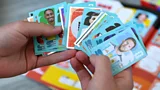 A collection of World Cup 2026 stickers fanned in someone's hands (Credit: Alamy)