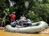 Porter Yusofu and Sakpa (right) load Will's packraft `Shostakovich' before setting out down the Moro River