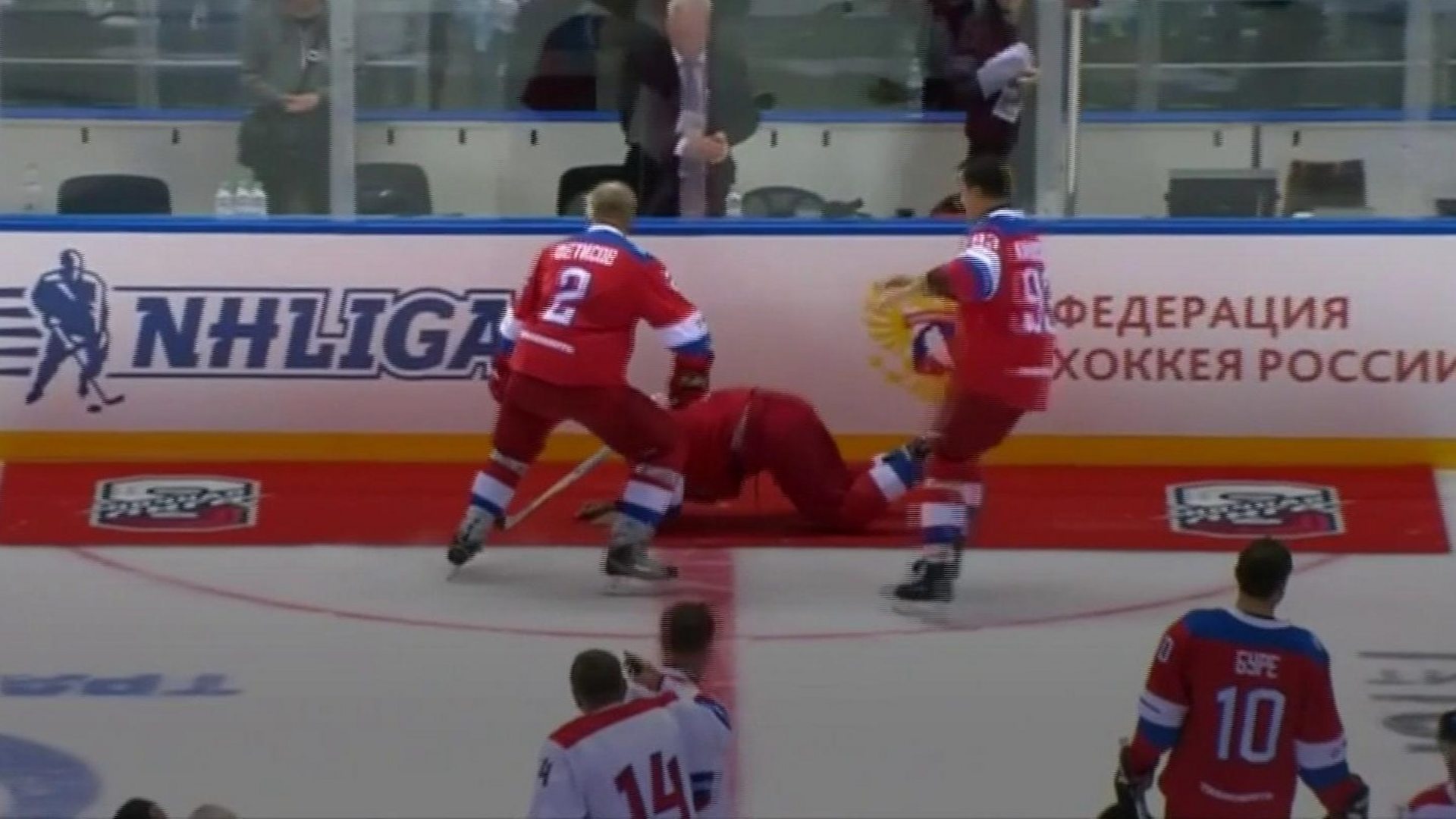 Russia's President Putin falls on ice after hockey match - BBC News