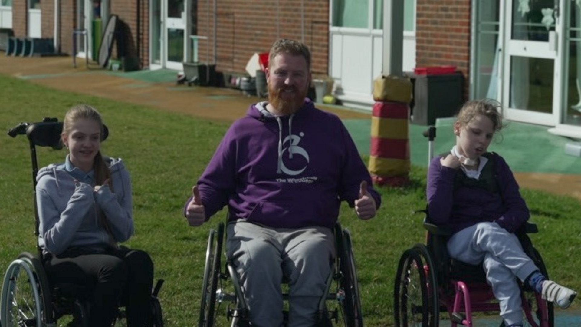 The man teaching children how to use wheelchairs