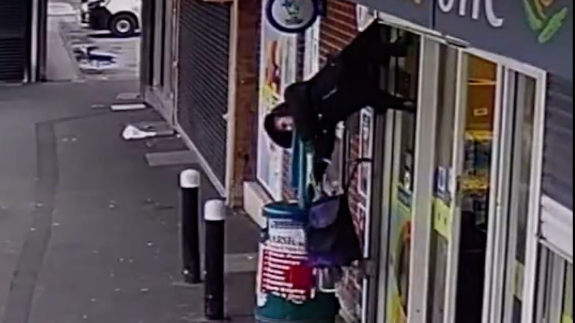 Watch: Woman hoisted into the air by shop shutters