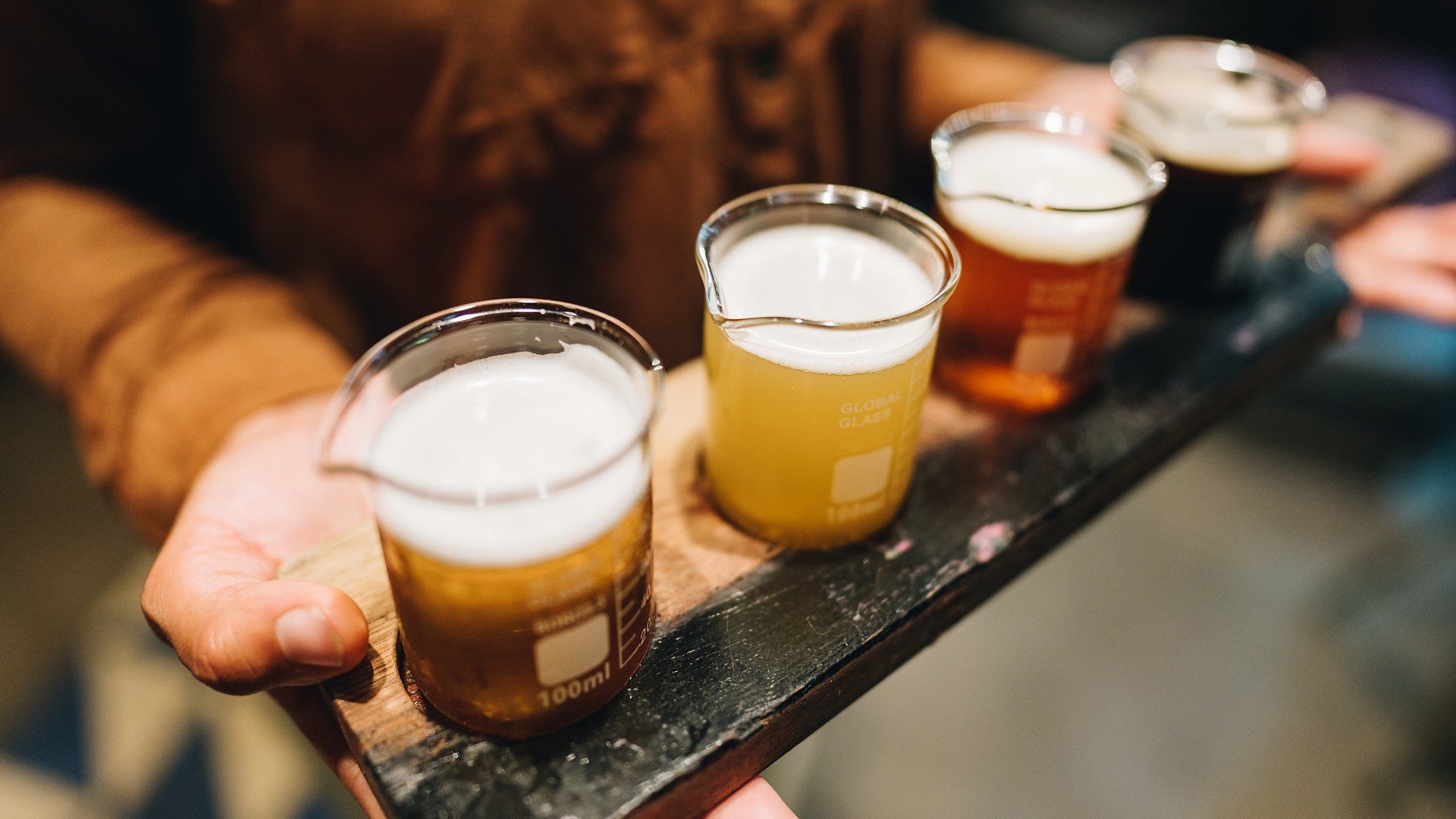 Close-up of waitress holding craft beer at bar, Brazil (Credit: FG Trade via Getty Images)