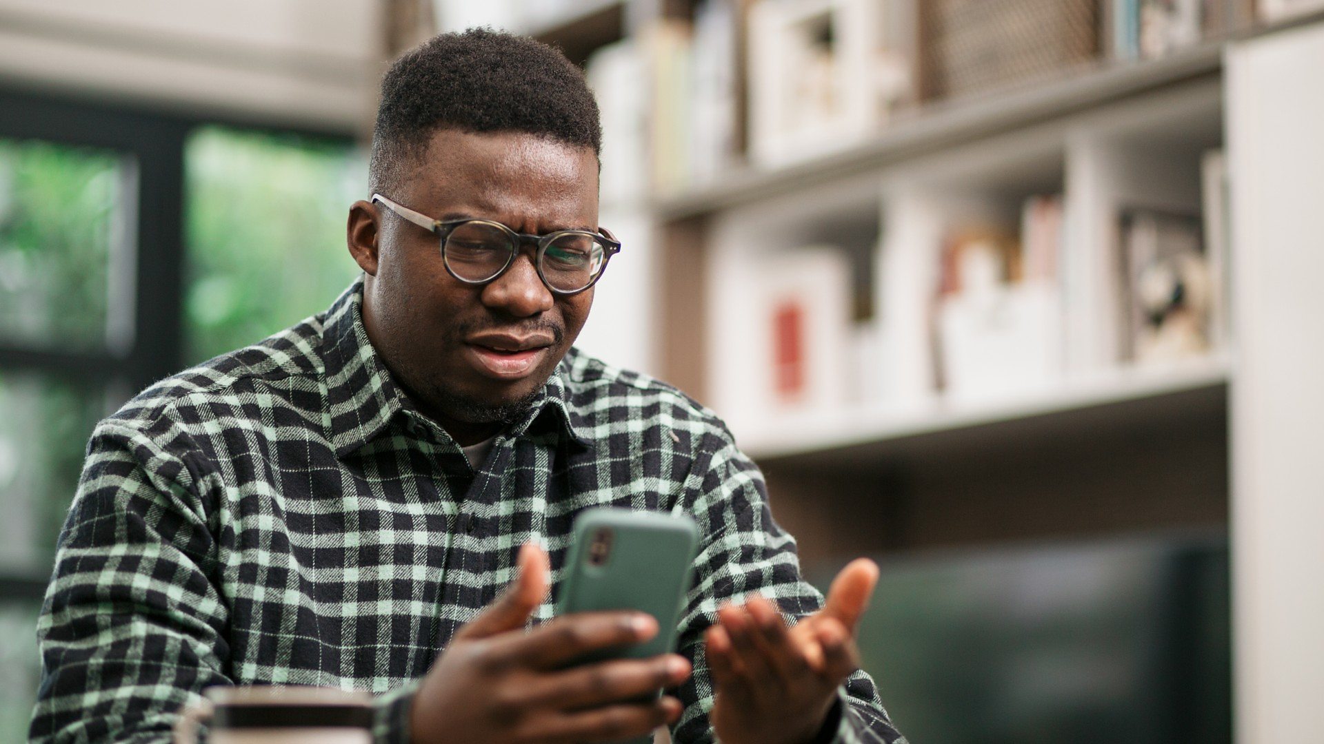 A man looking confused at his phone (Credit: Getty Images)