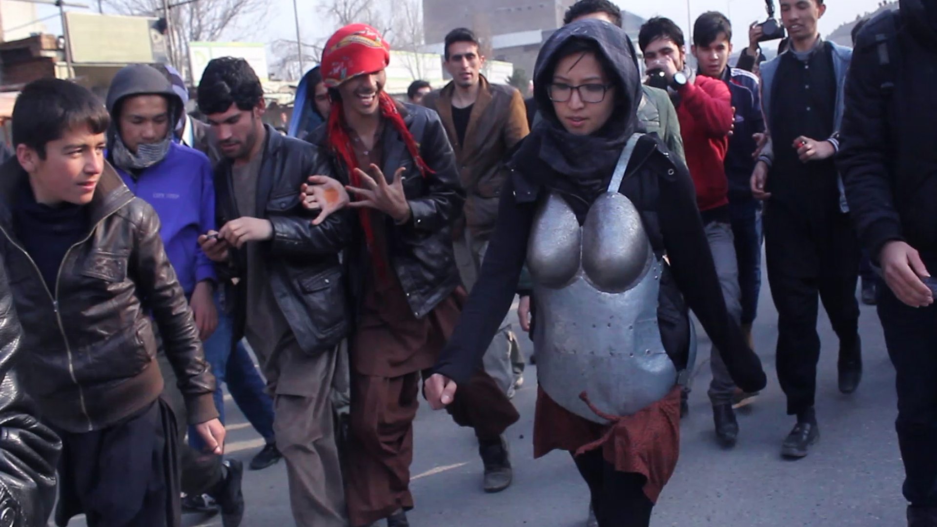 Kubra Khademi being leered at during her armour performance in Kabul, 2015 (Credit: Naim Karim)