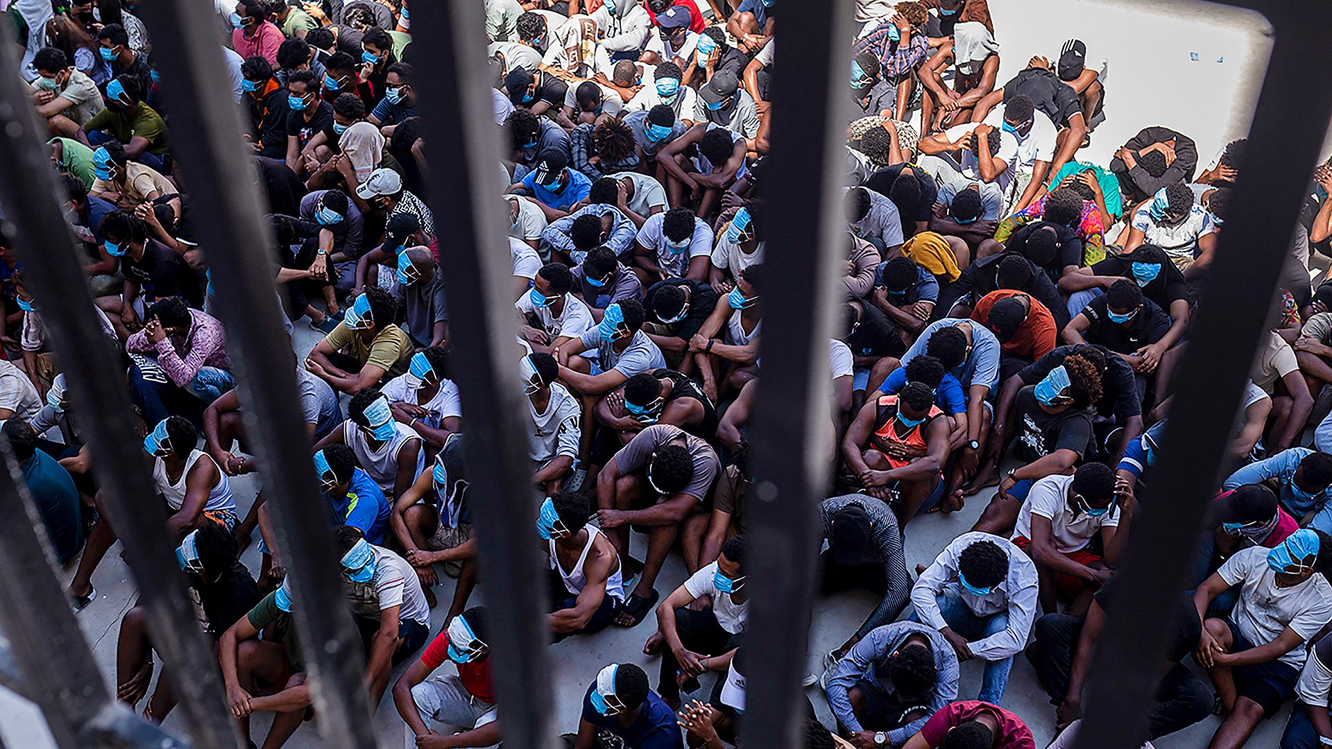 Alleged scam centre workers and victims sit on the ground during a crackdown operation by the Karen Border Guard Force (BGF) ( redit: AFP/Getty Images)