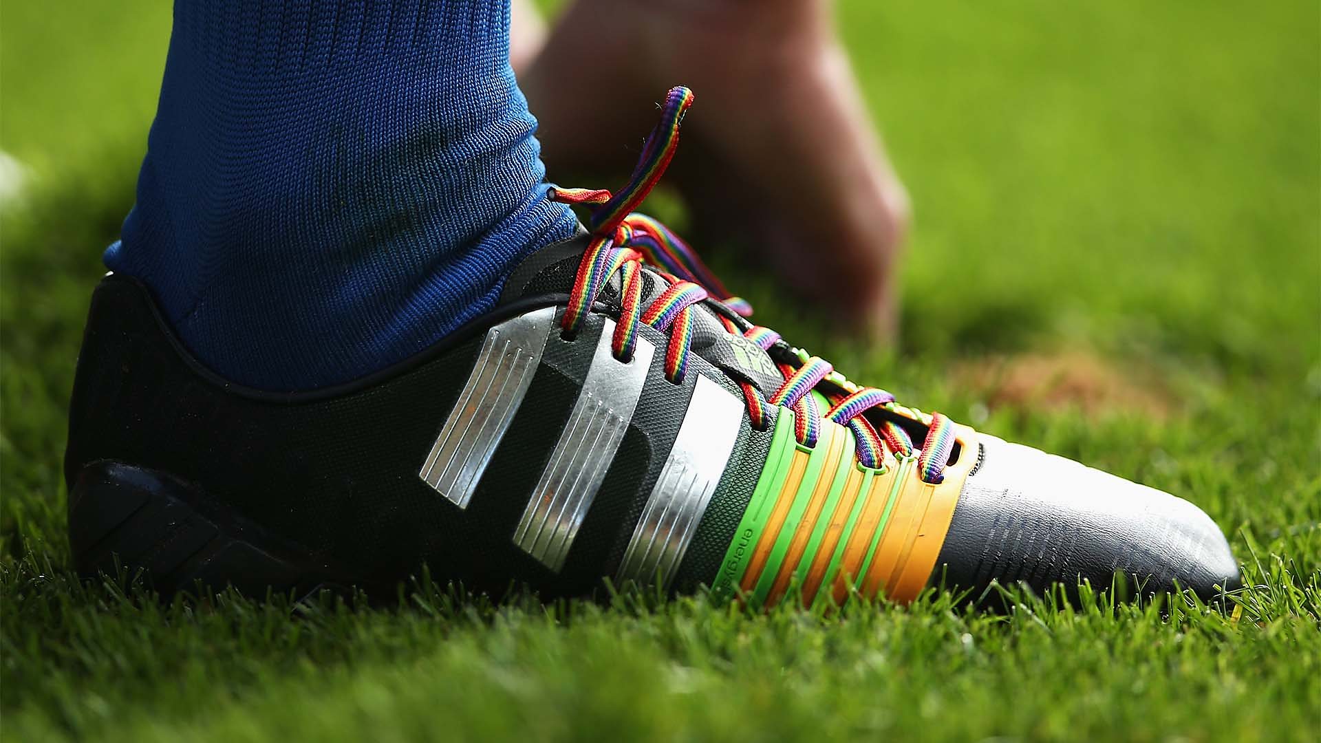 A football boot with rainbow laces