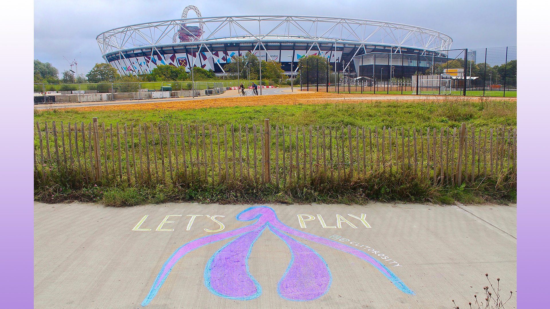 A chalk drawing of a clitoris on a pavement