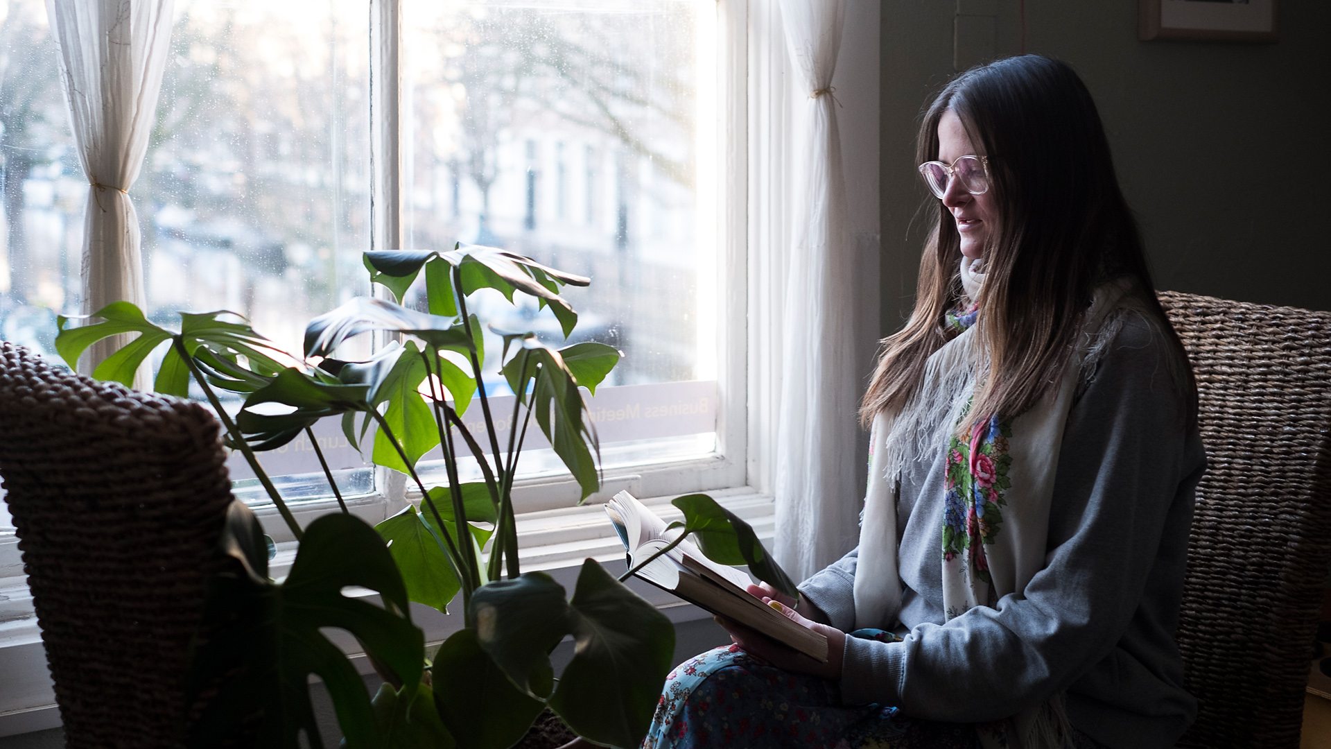 Indoors reading to the plants