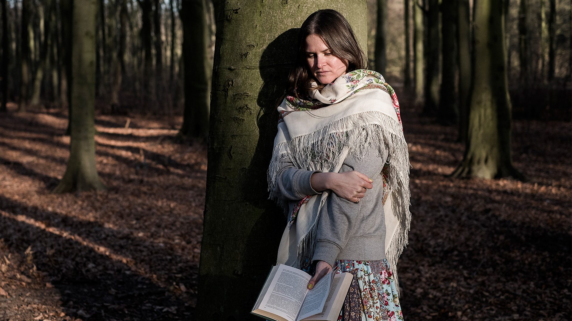 Anastasia reading in the fores...