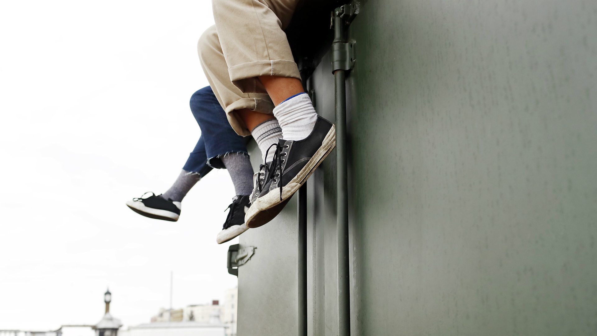 A group of young people sitting on a wall