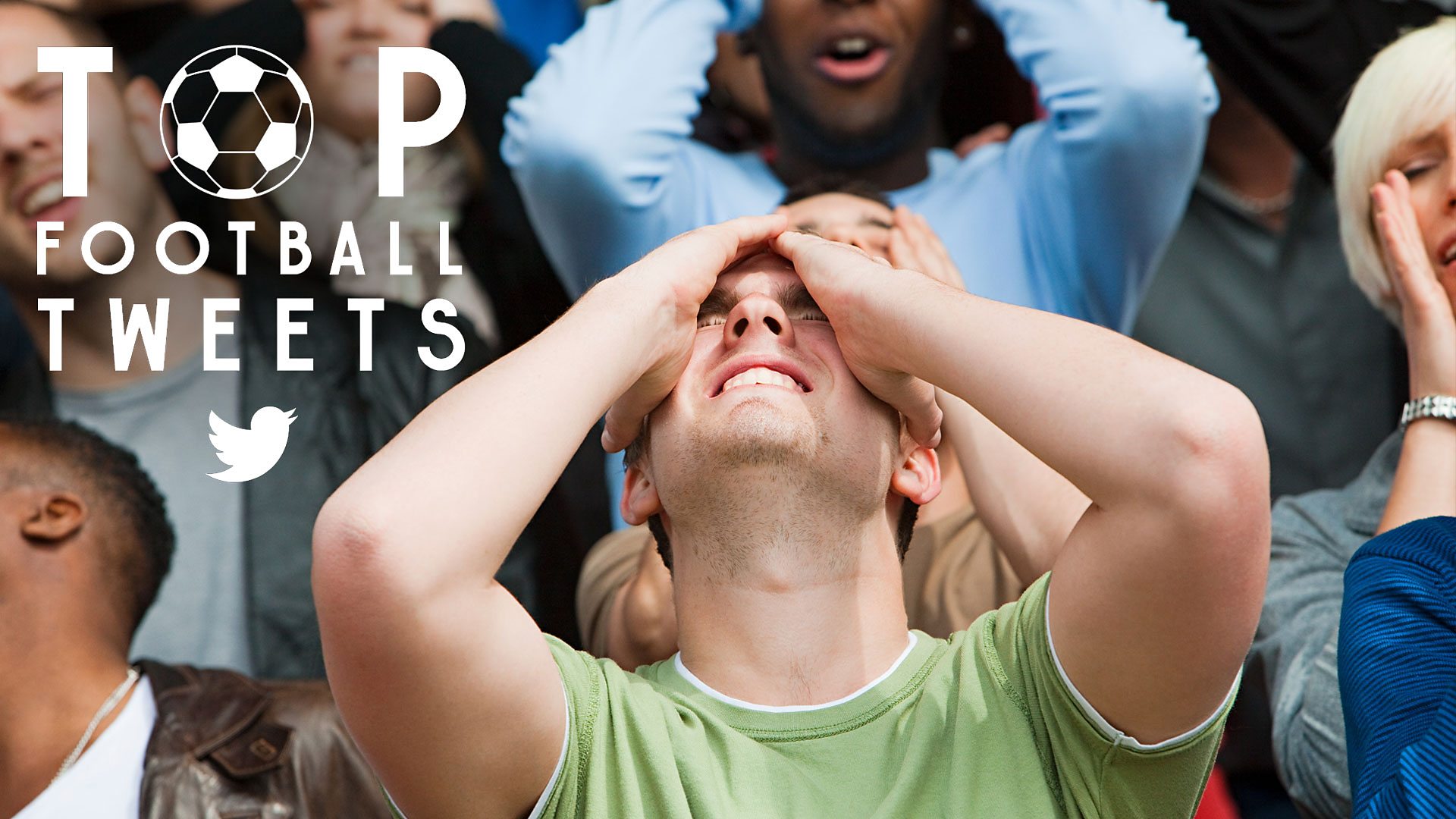 A fan clutching his head in his hands