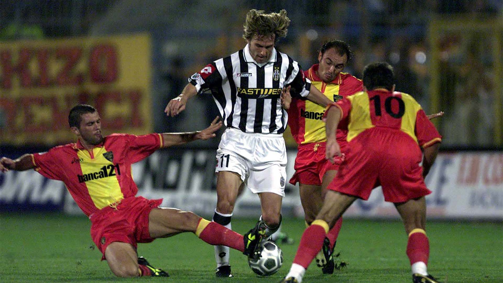 Three players try to tackle Pavel Nedved