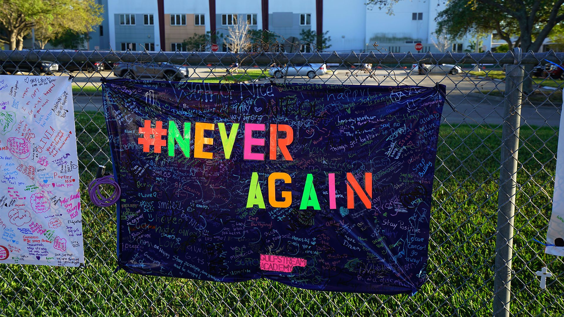 A banner with the hashtag 'never again' hung outside Marjory Stoneman Douglas High School