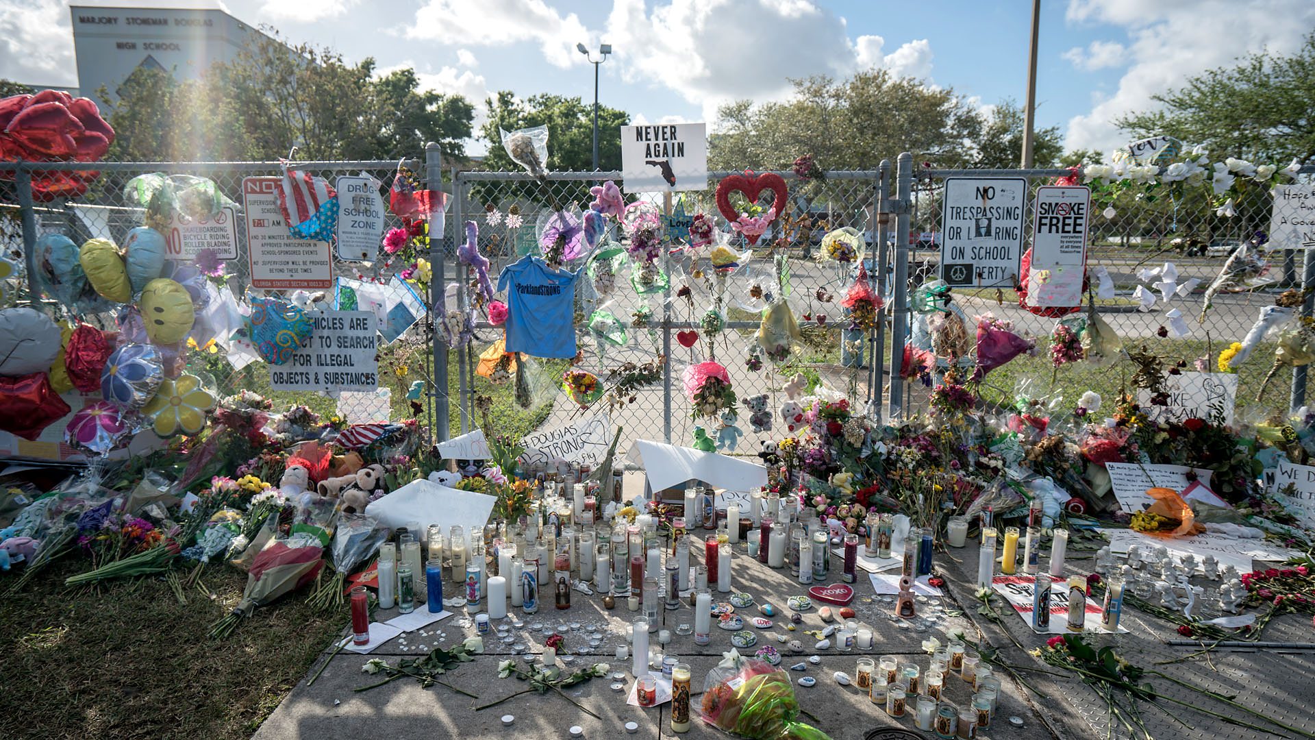 A photo of the school gates, covers in flowers and messages following the shooting