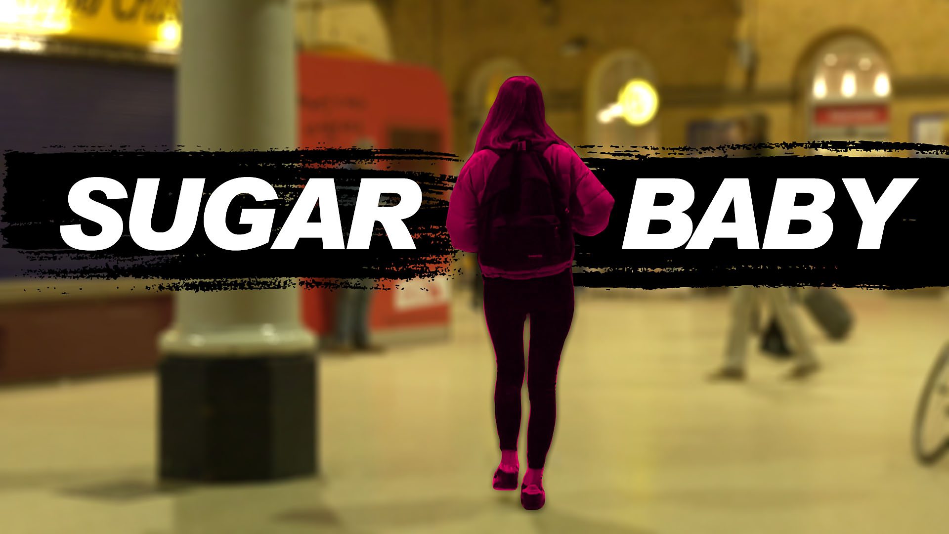 Young woman walks across a train station