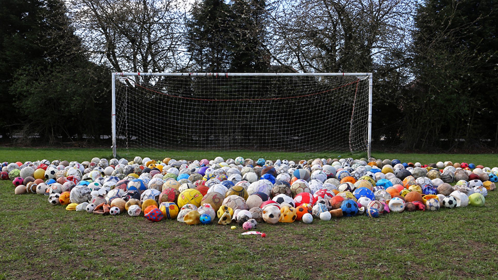 Footballs laid out on pitch