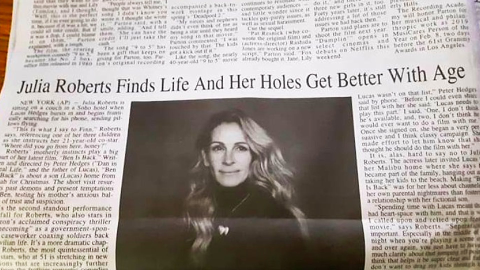 Newspaper with a photo of Julia Roberts and the headline: "Julia Roberts finds life and her holes get better with age"