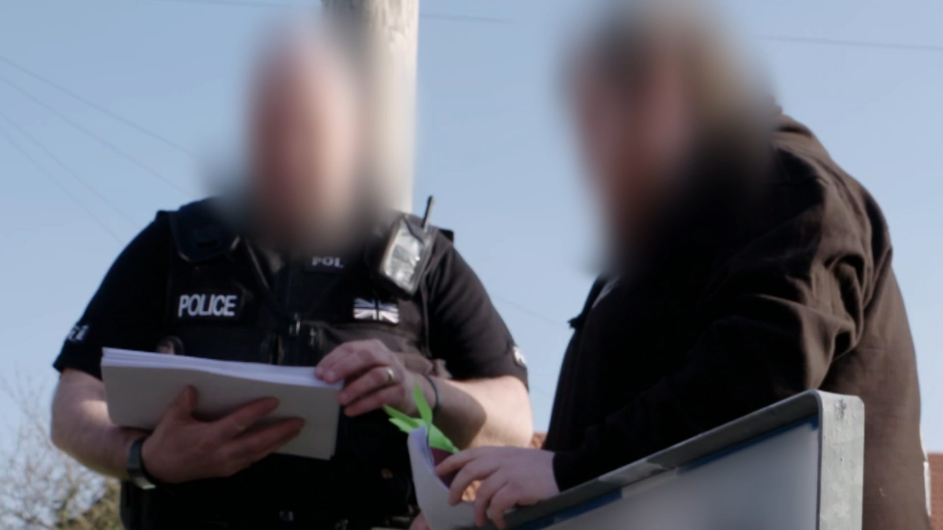 A still showing evidence collected by Guardians of the North being handed over to the police