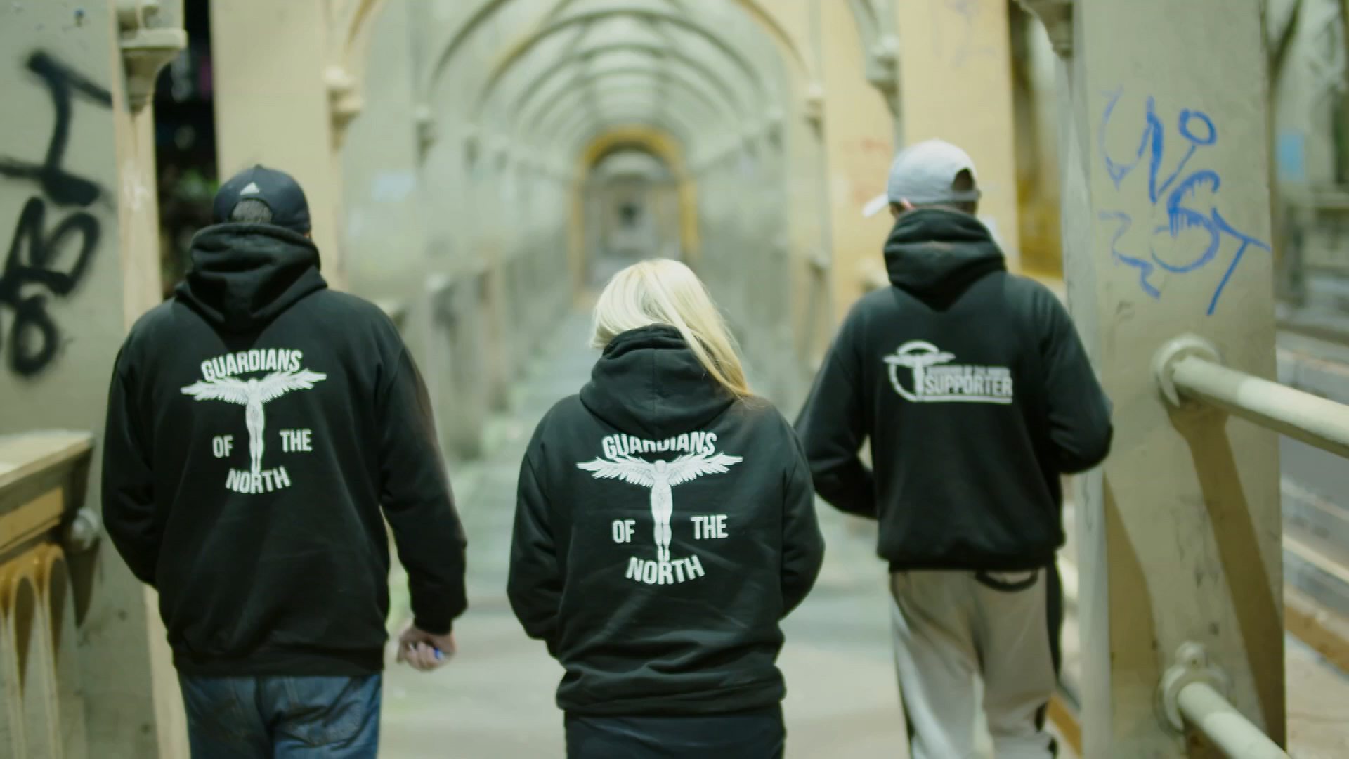 Three members from the paedophile hunting group Guardians of the North with their backs to camera