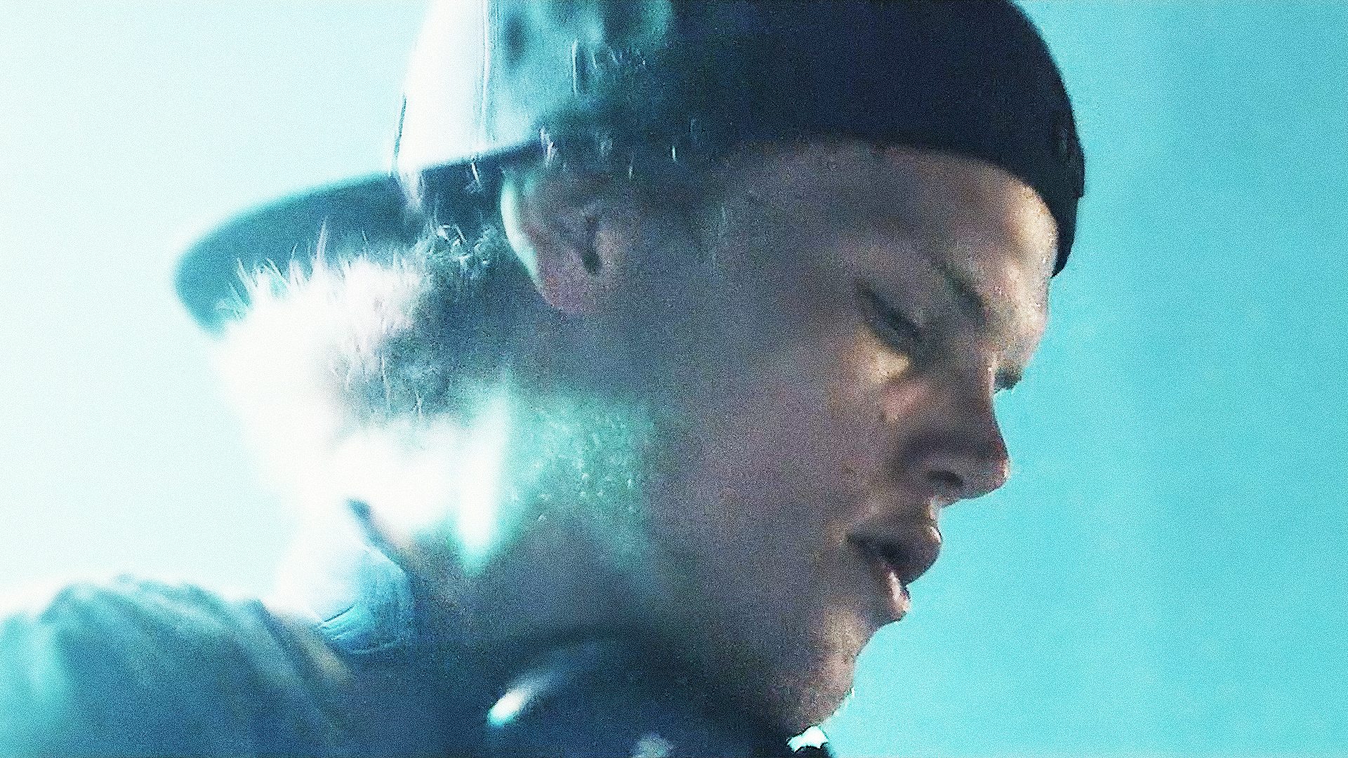 A close up of a perspiring Avicii on stage during one of his concerts