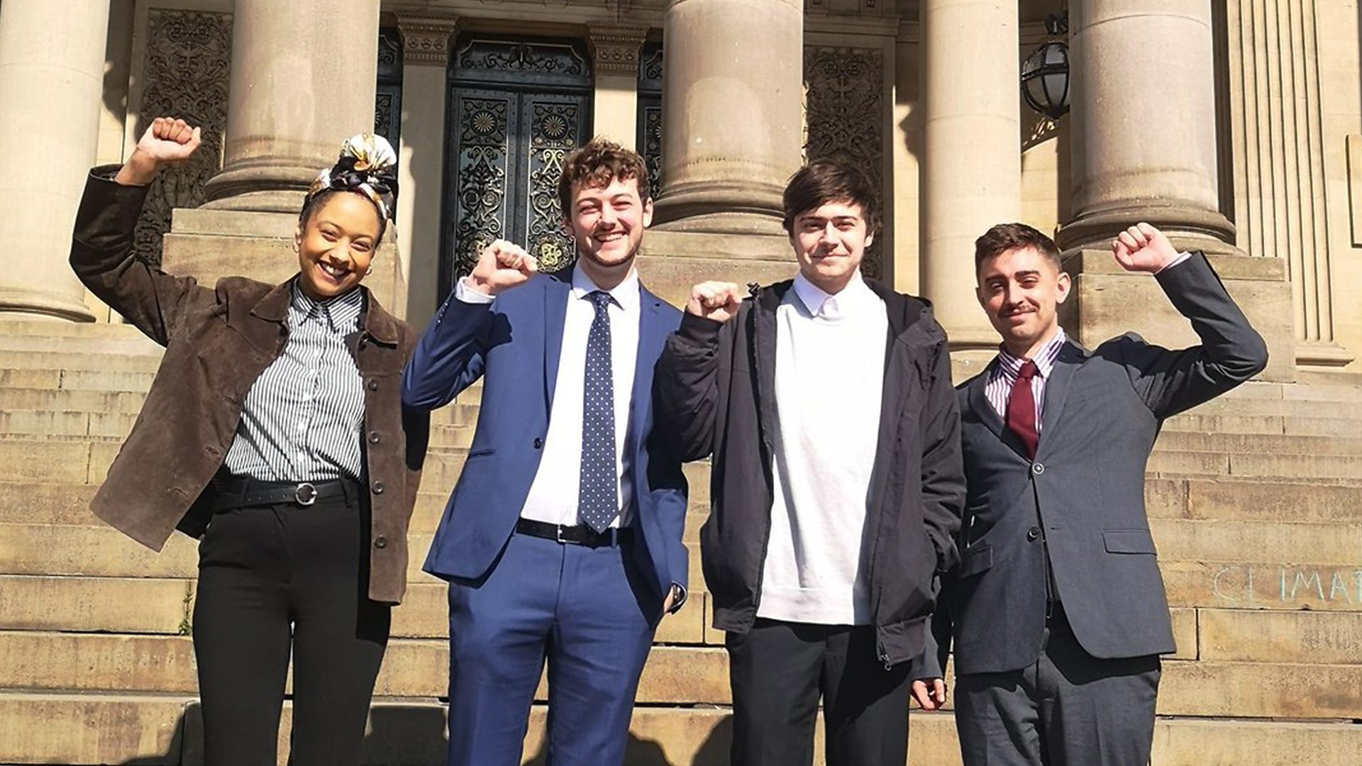 Four tenants who successfully sued their landlord celebrate outside court