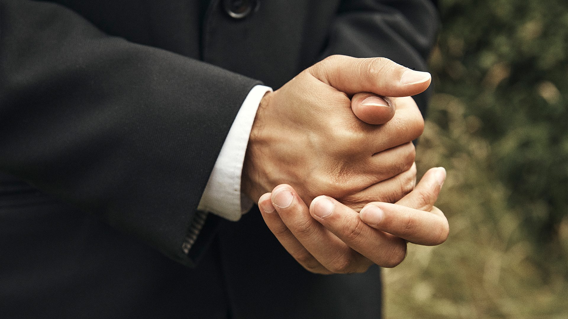 Waleed clasped hands