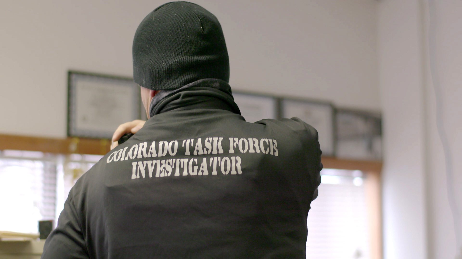 One of the bounty hunters prepares to leave their office