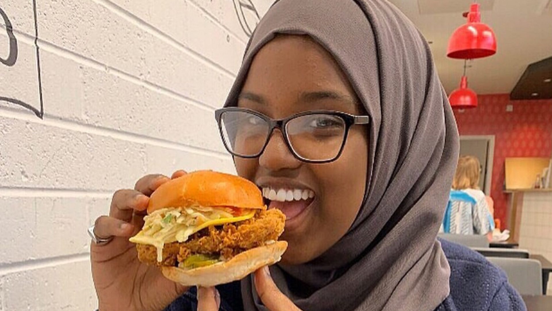 Sumaya eating a vegan burger