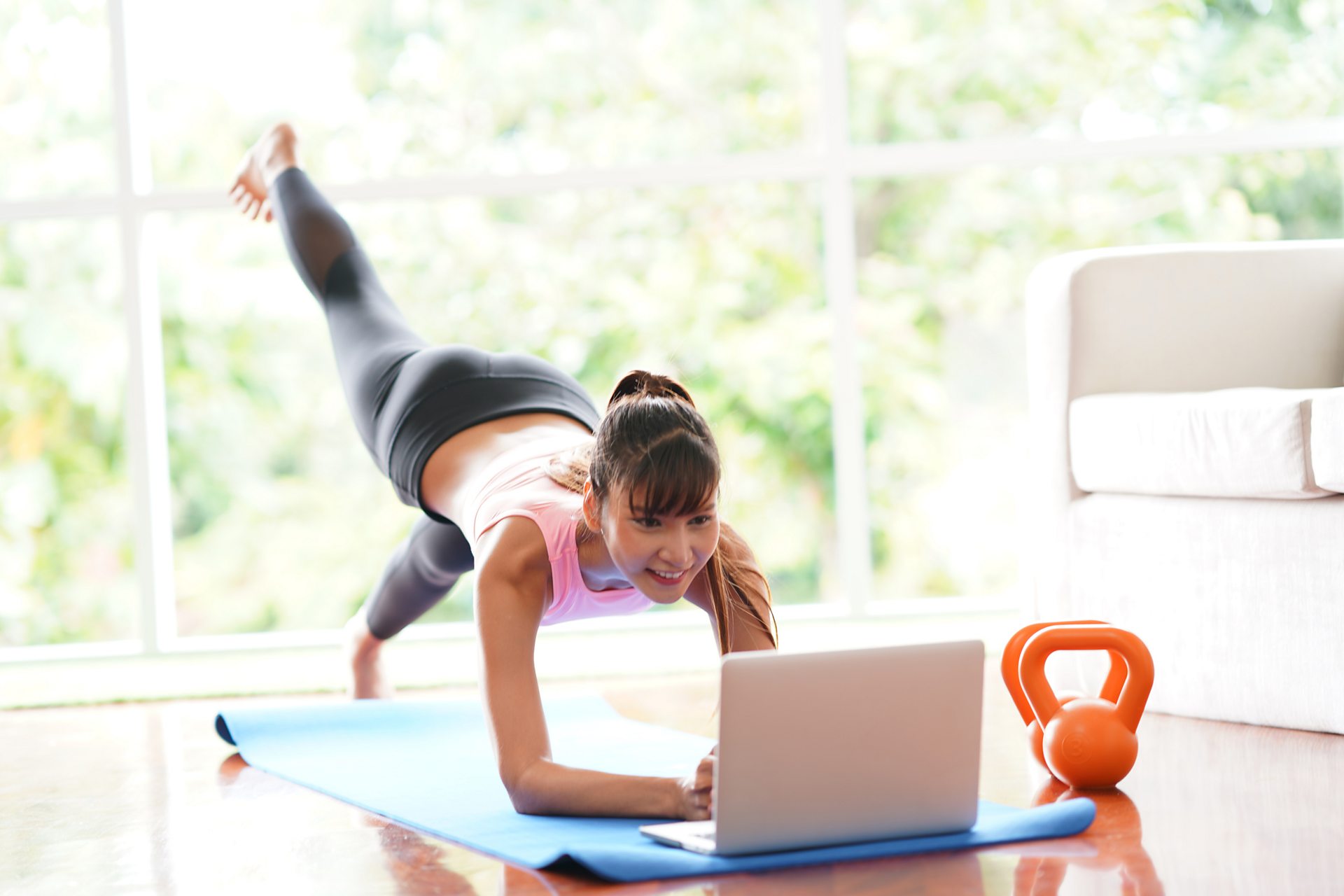 A woman doing an online fitness class