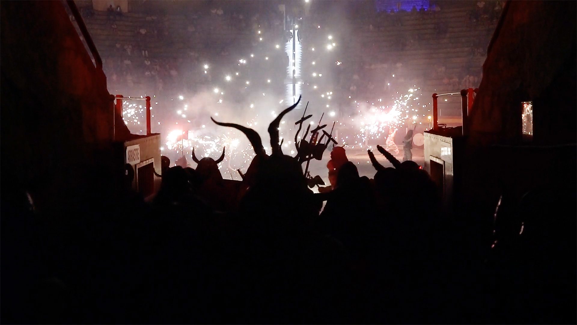 The silhouettes of 'demonic' characters watching a traditional 'correfoc' display in Spain.