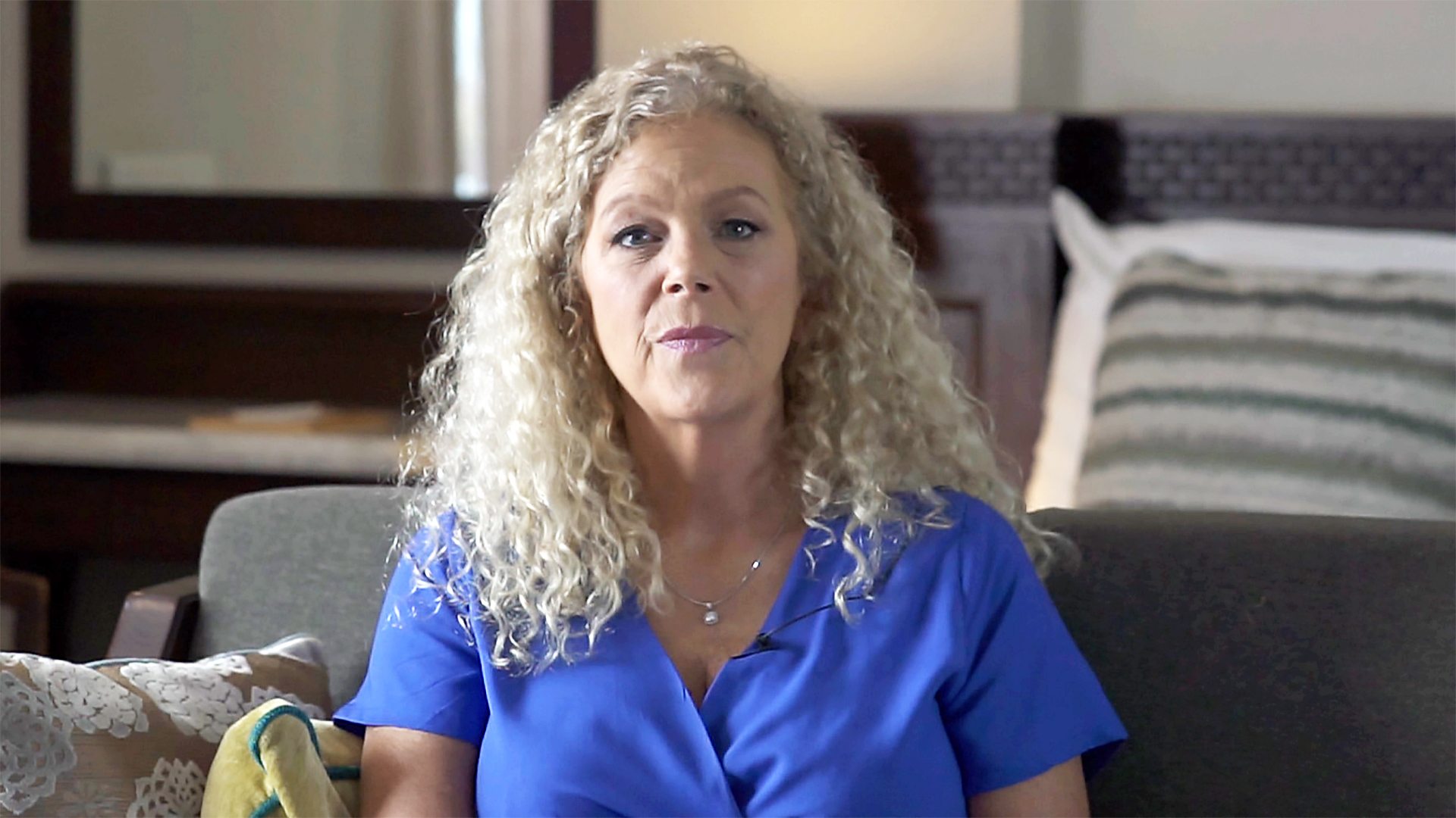 A woman in a hijab with a serene expression in a beauty salon