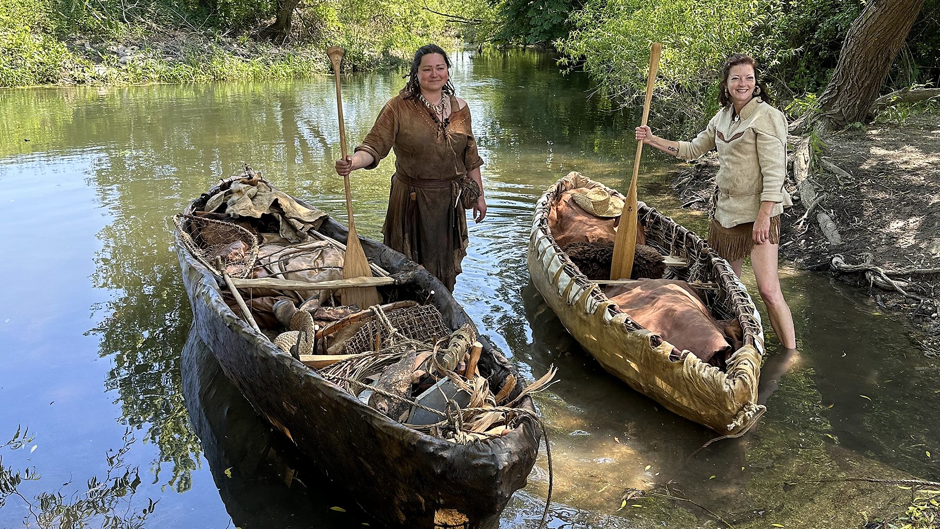 Theresa Emmerich Kamper and Sarah Day standing next to skin boats